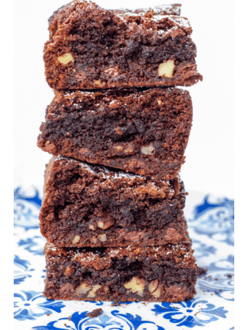 four brownies stacked high on a blue plate