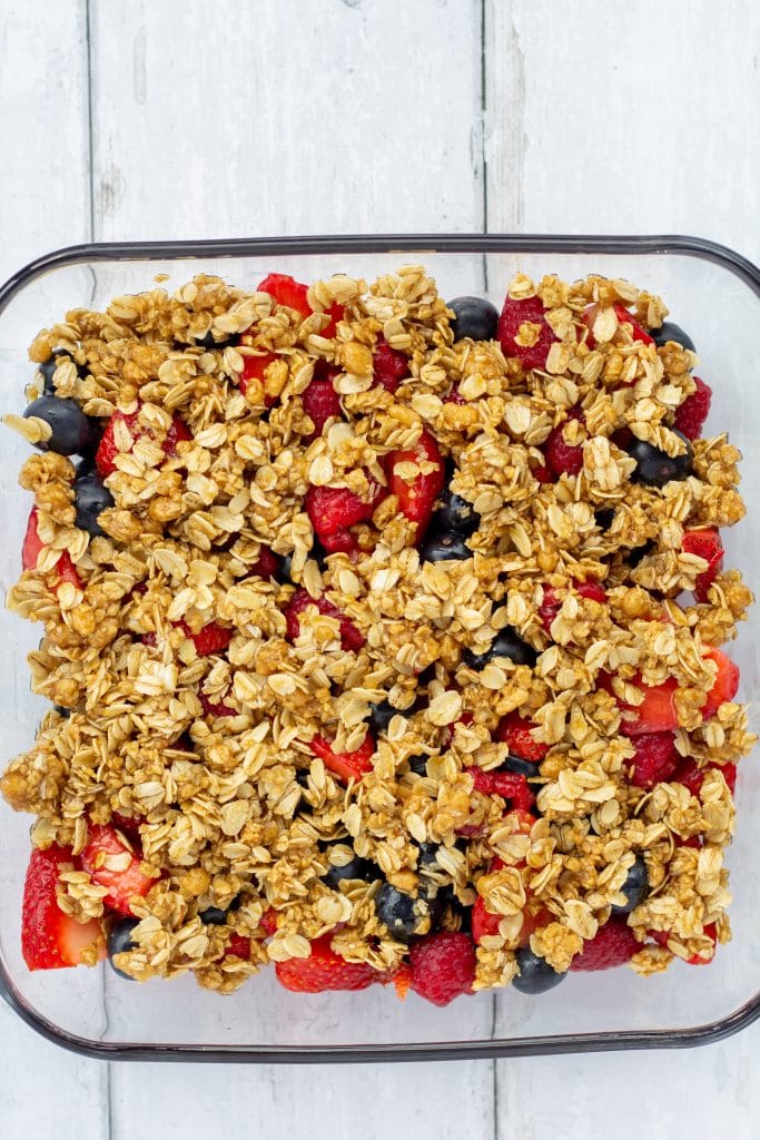 fruit crisp in a glass pan on a white background