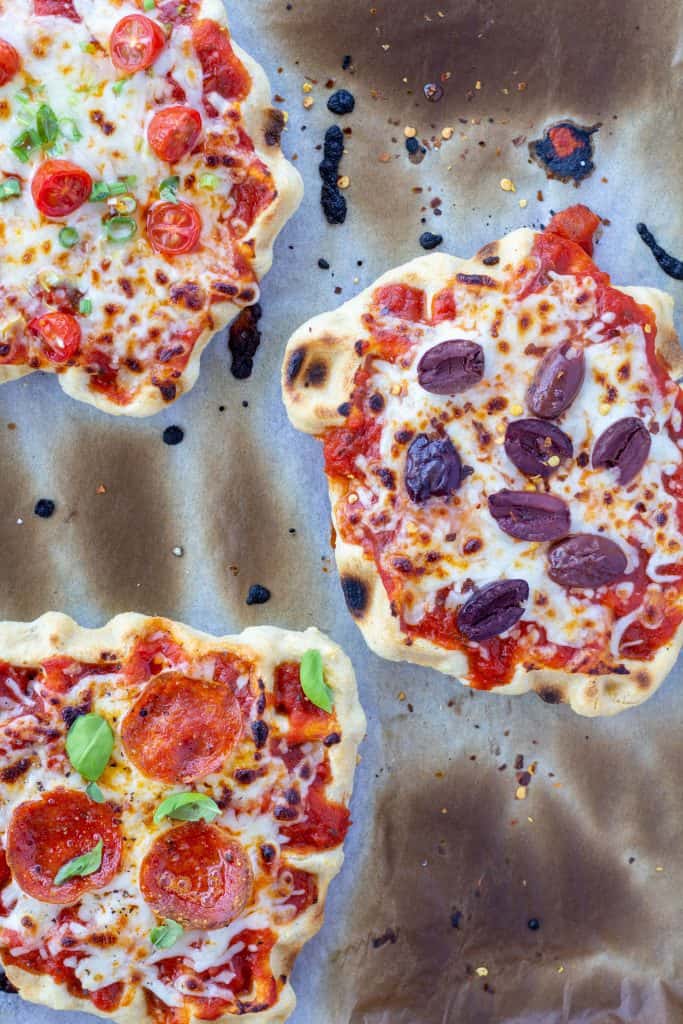 three waffle iron pizzas, individual, on a white background