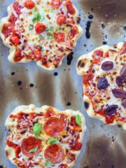 three waffle iron pizzas, individual, on a white background