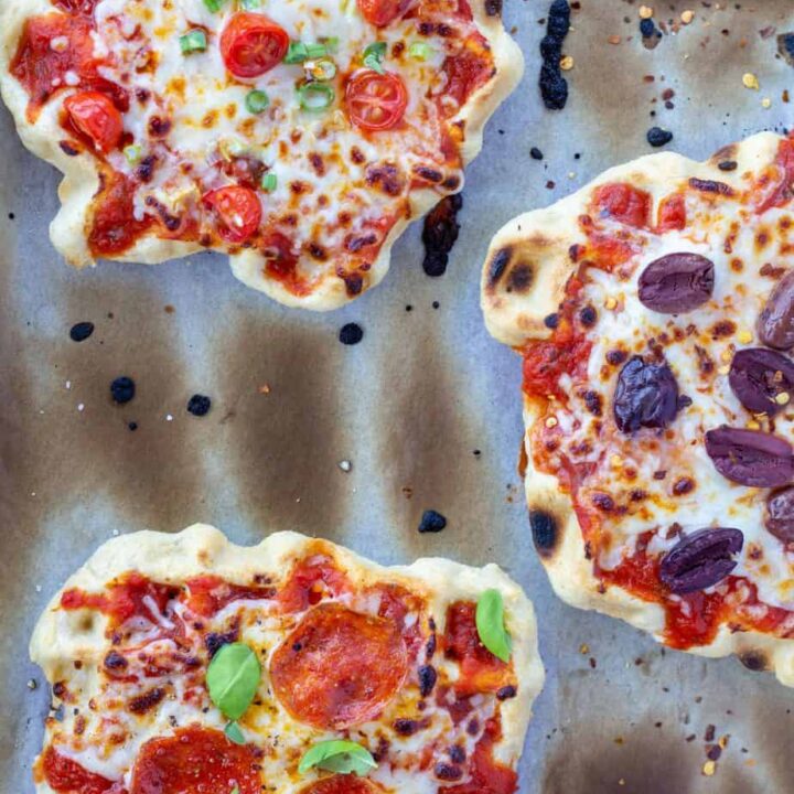 three waffle iron pizzas, individual, on a white background