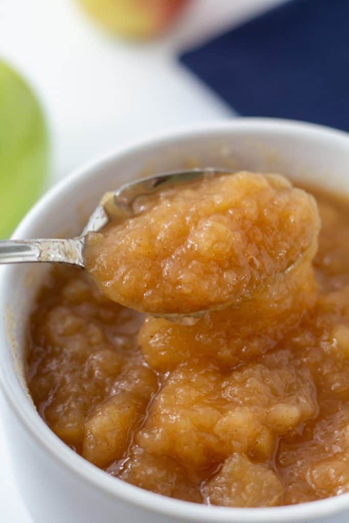 applesauce in a white bowl on a spoon