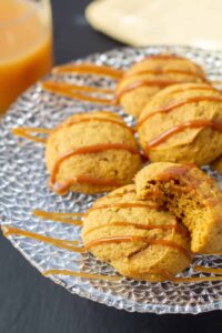 pumpkin cookies drizzled with caramel on a plate