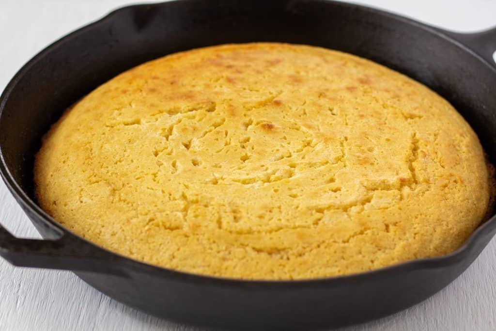 Cast-iron Skillet Cornbread in a pan on a white background