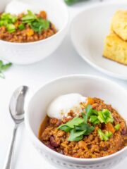 chili in a white bowl with a spoon