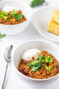 chili in a white bowl with a spoon