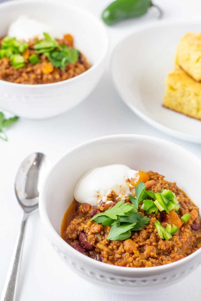 chili in a white bowl with a spoon 