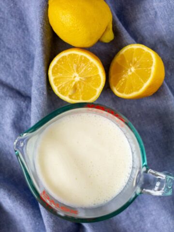 buttermilk on a blue background with cut lemons