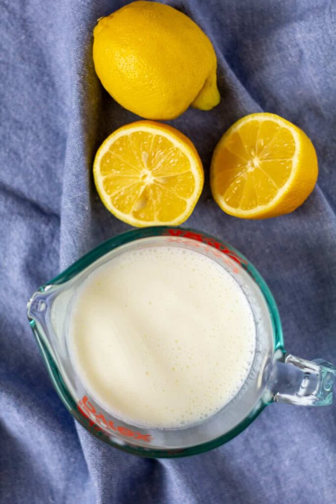 buttermilk on a blue background with cut lemons