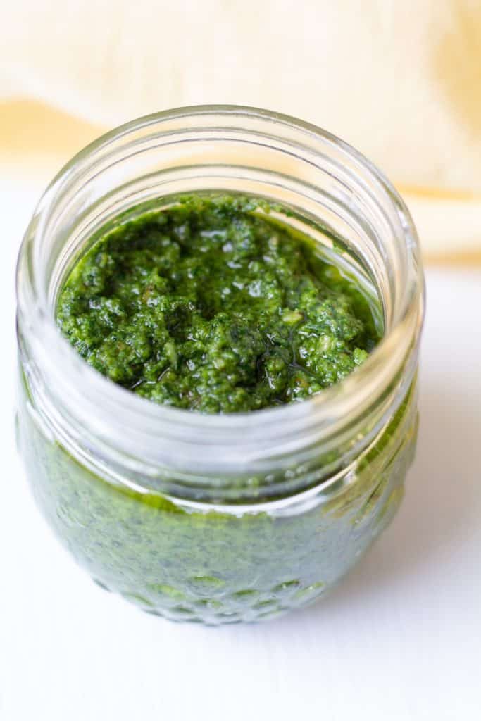 pesto in a jar on a white background