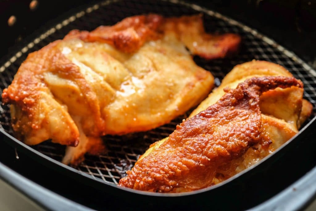 Fried chicken in the basket of an air fryer