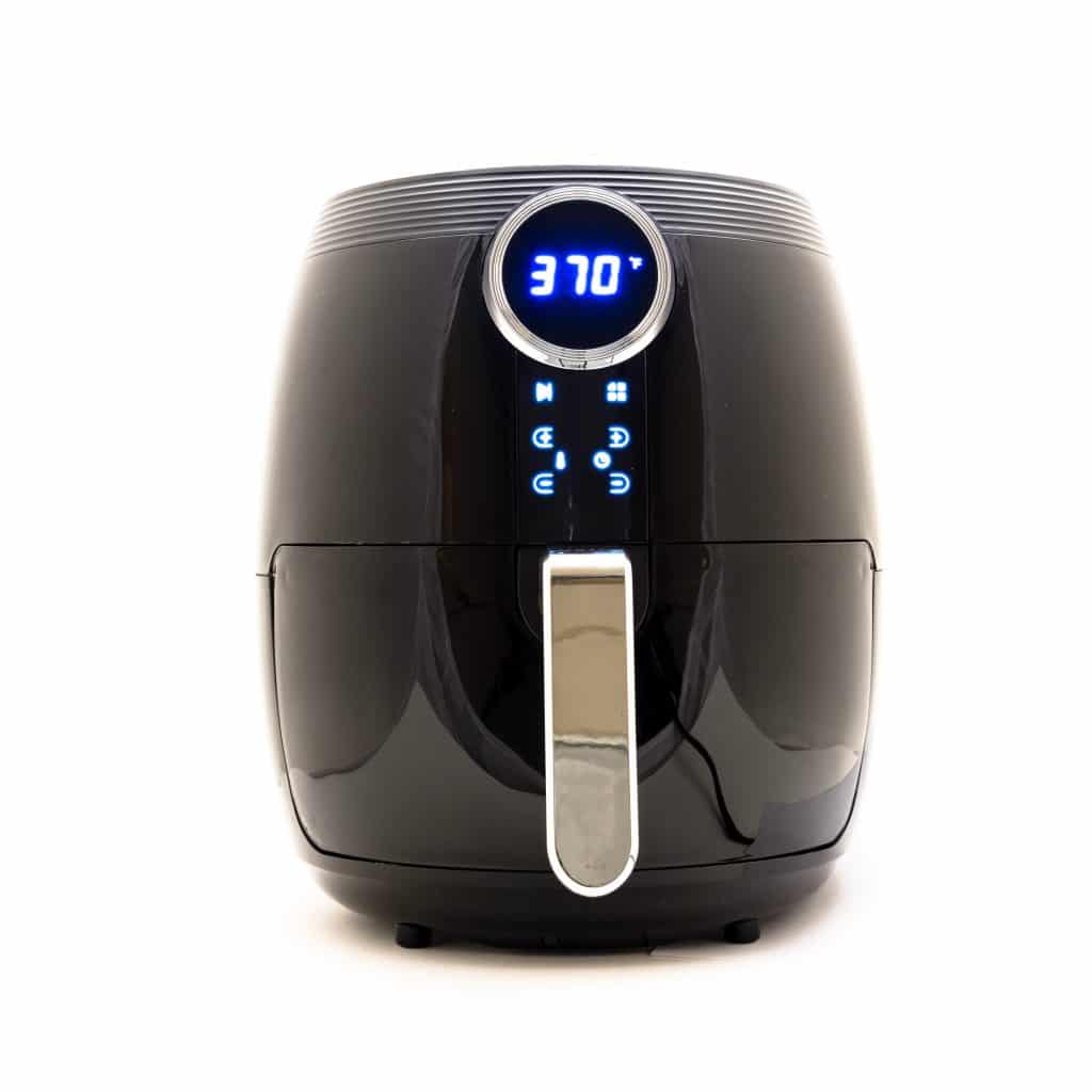 Black air fryer with a white background.