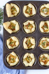 cooked pastry puffs with filling in a muffin sheet