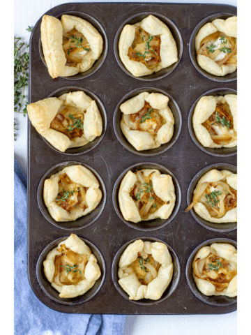 cooked pastry puffs with filling in a muffin sheet