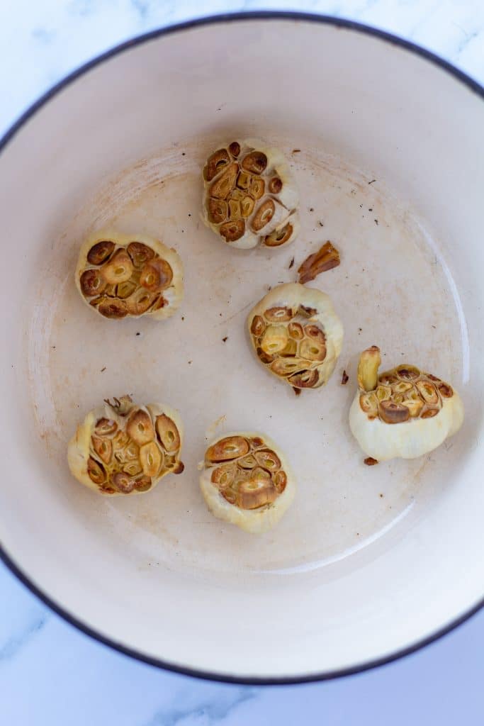 heads of roasted garlic in a large pot