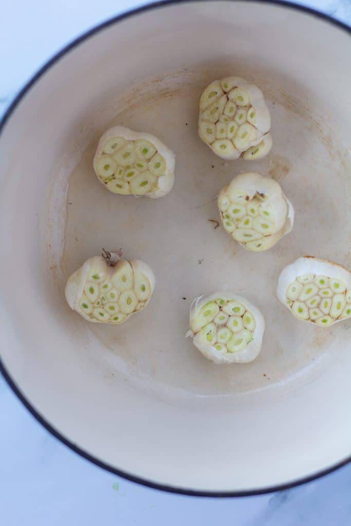 heads of raw garlic in a large pot