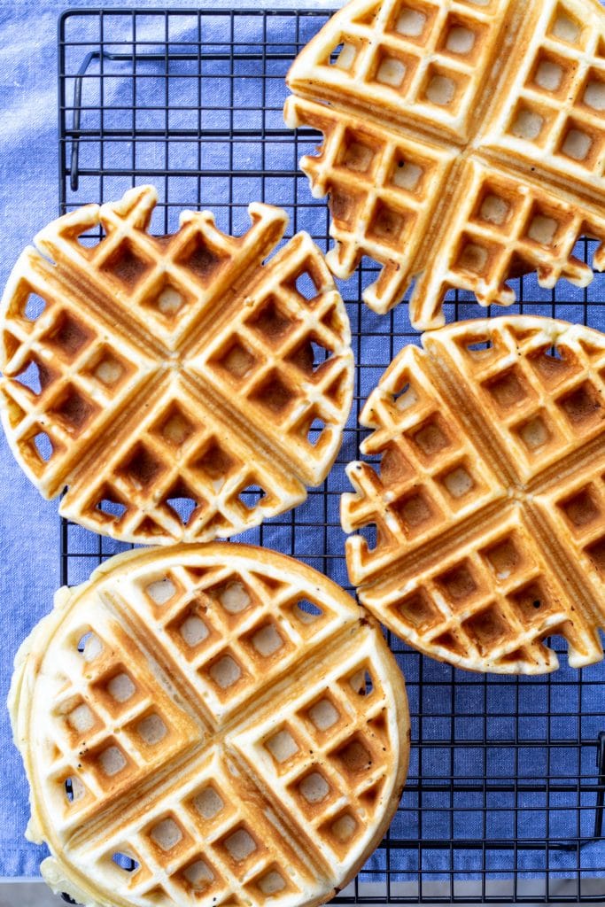 Waffles on a cooling rack with a blue background