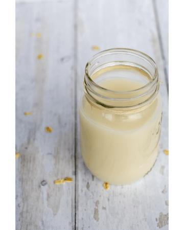 oat milk in a glass jar with a white background