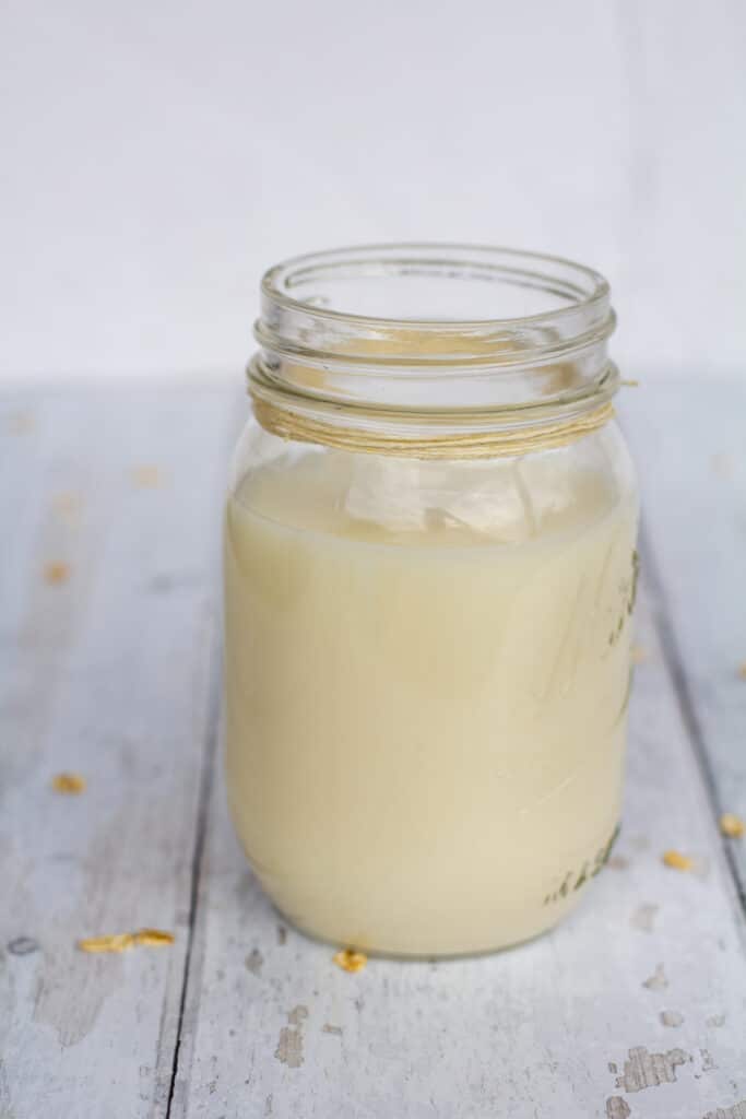 oat milk in a glass jar on a white background