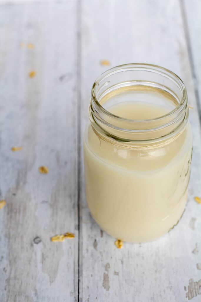 oat milk in a glass jar with a white background