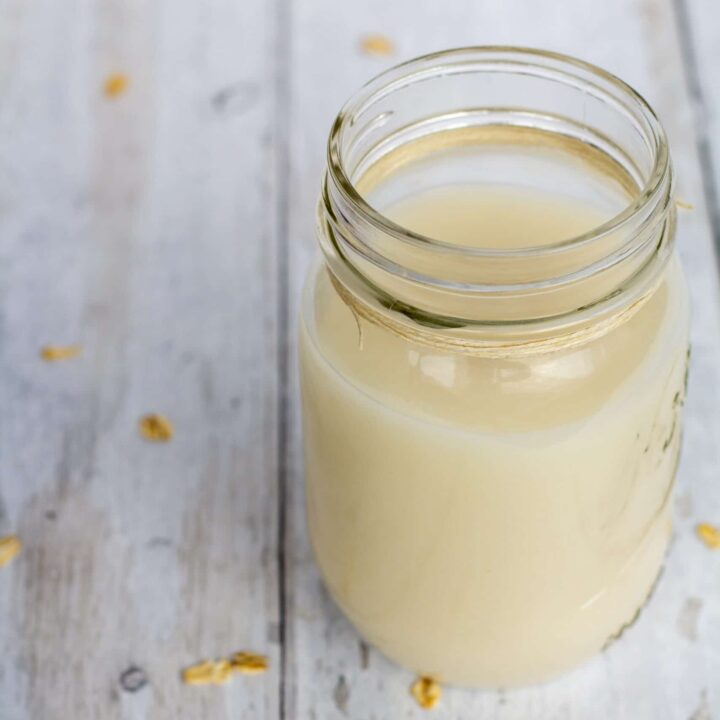 oat milk in a glass jar with a white background