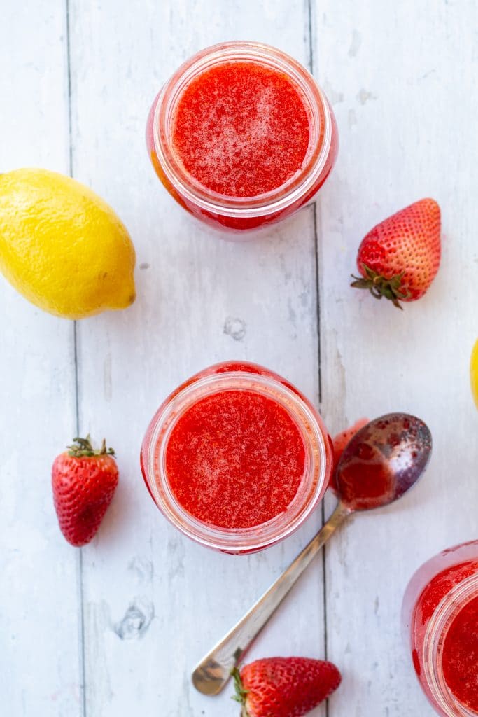 strawberry jam on a white background in jars in an overhead shot