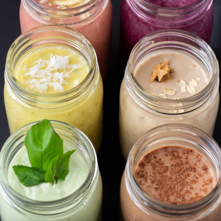 six smoothies lined up in a row on a black background