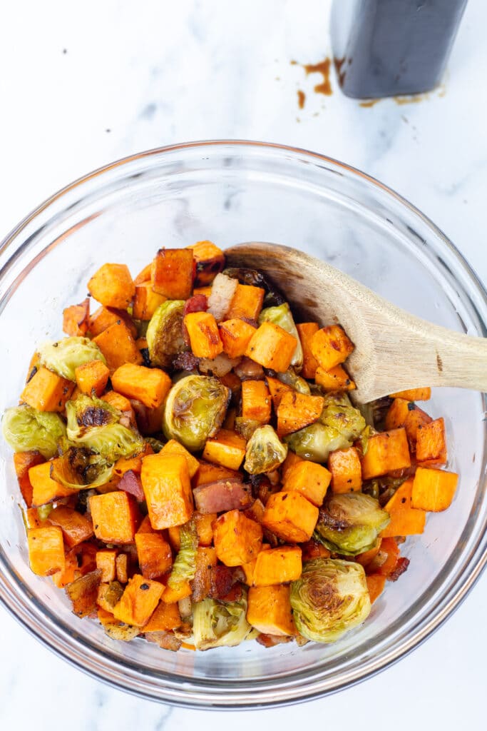 Colorful mix of brussel sprouts and sweet potatoes on a bright white background