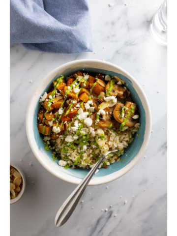 Feature photo of a bowl with vegetables, rice, and sauce on a white marble background