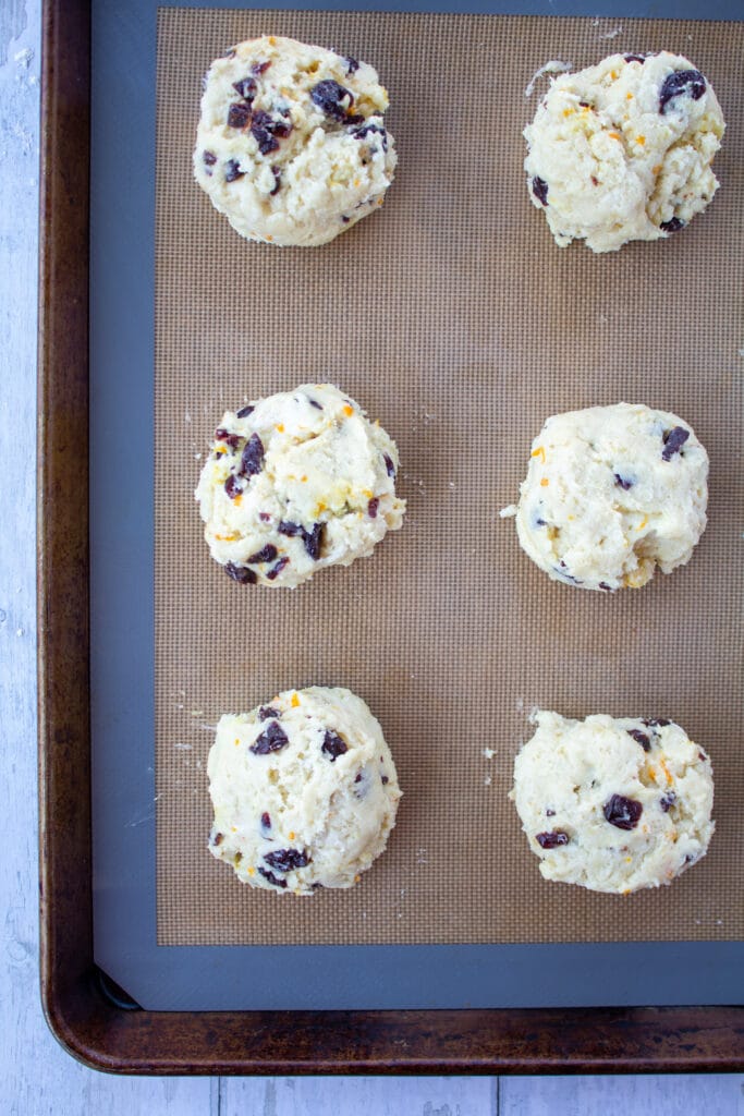 biscuit shaped scones on a baking sheet