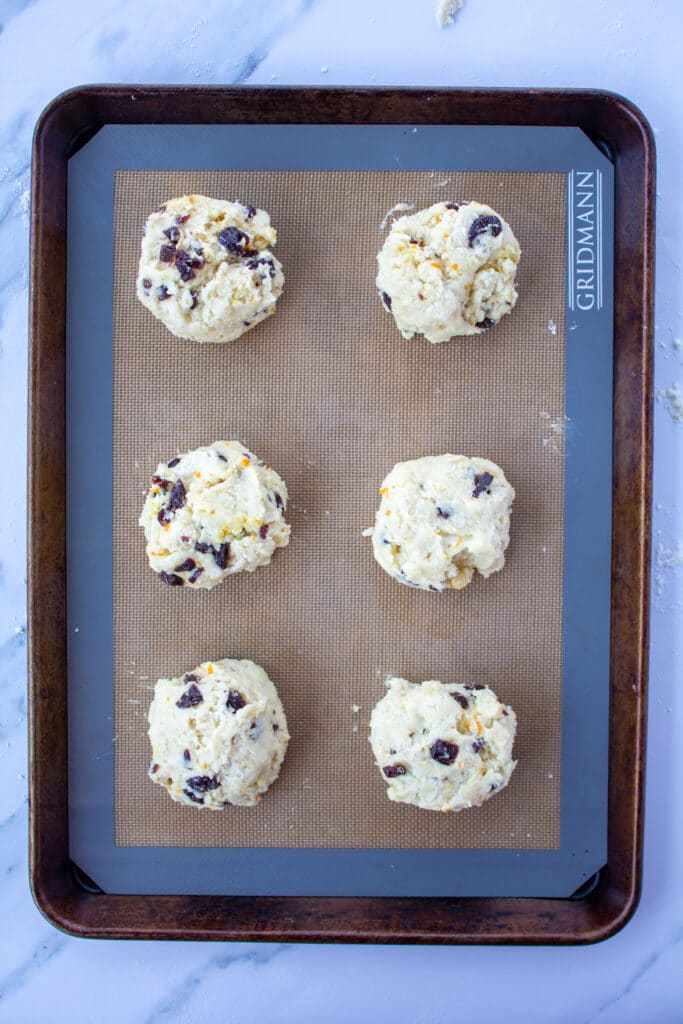 biscuit shaped scones on a baking sheet zoomed out