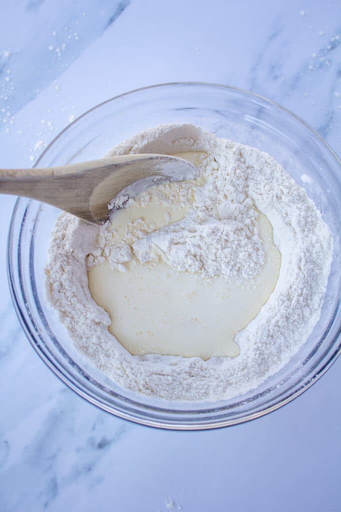beginning to stir flour and cream together in a glass bowl