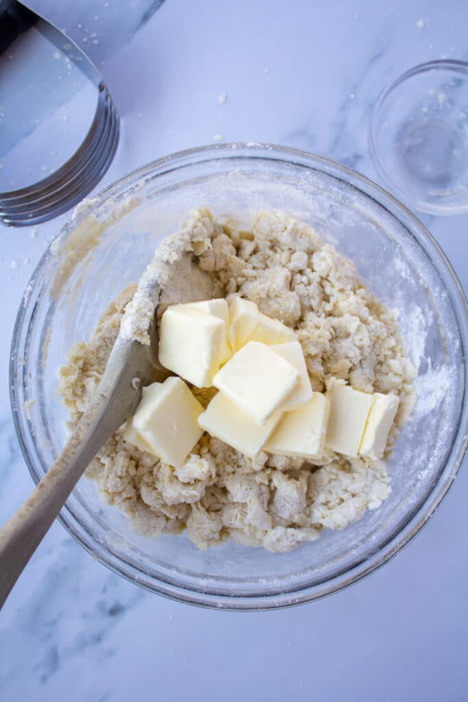 Adding in the butter to a flour and cream mixture
