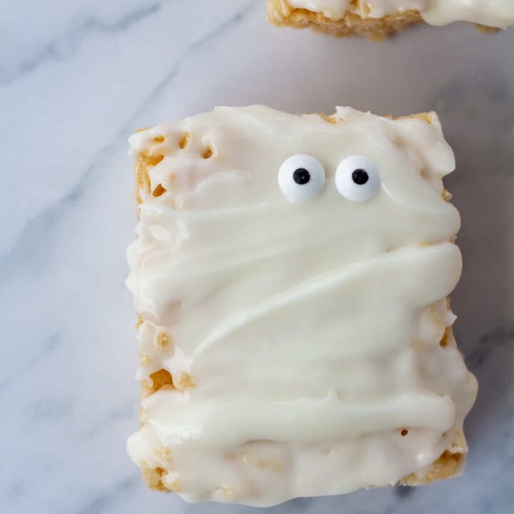 One mummy rice crispy treat with googly eyes on a white marble surface