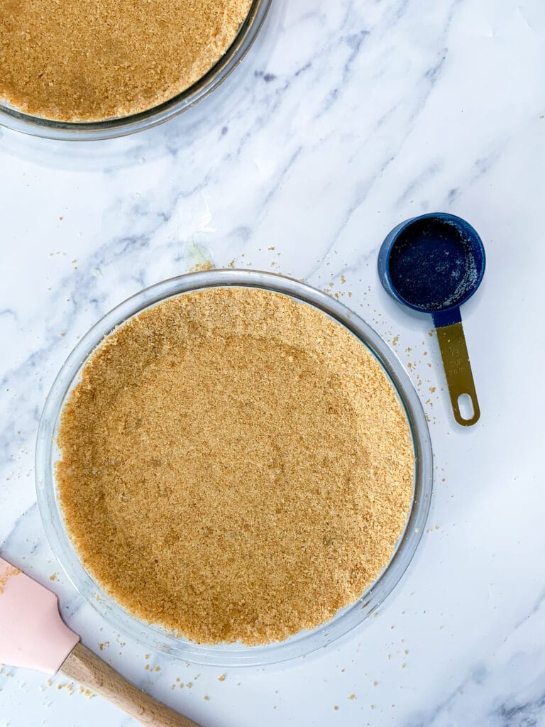 pie crust in a pan sitting on a white marble background