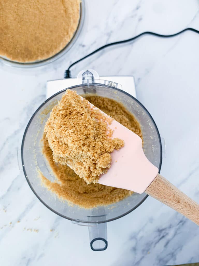 a spatula holding up the crust to the camera for a closer look