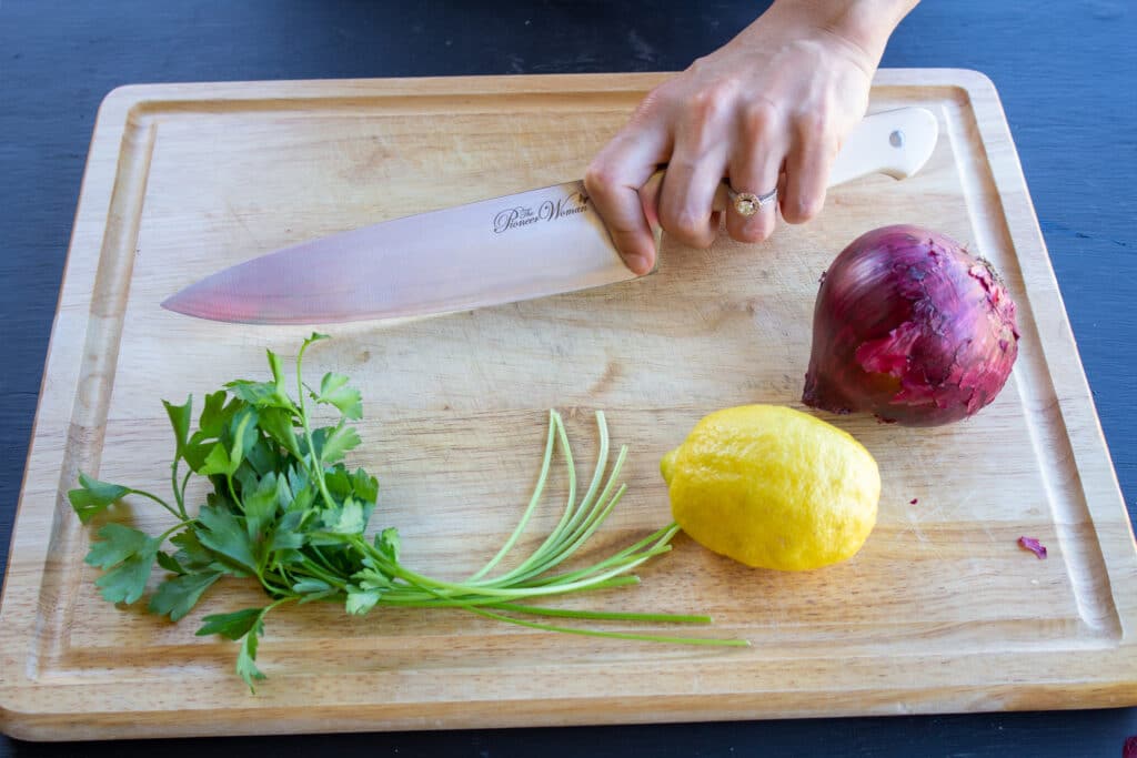 a hand holding a chef's knife from the front side