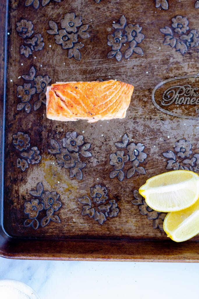 One piece of salmon on a baking sheet