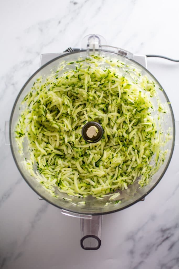 shredded zucchini in a food processor