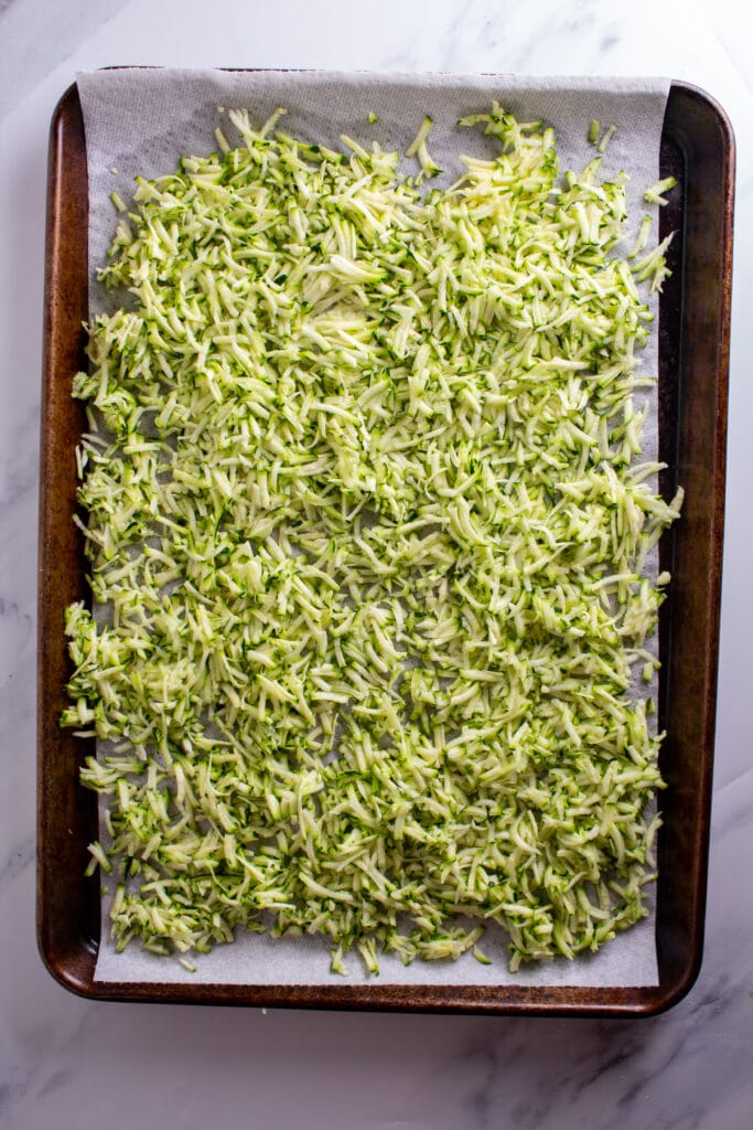 shredded zucchini on a baking sheet