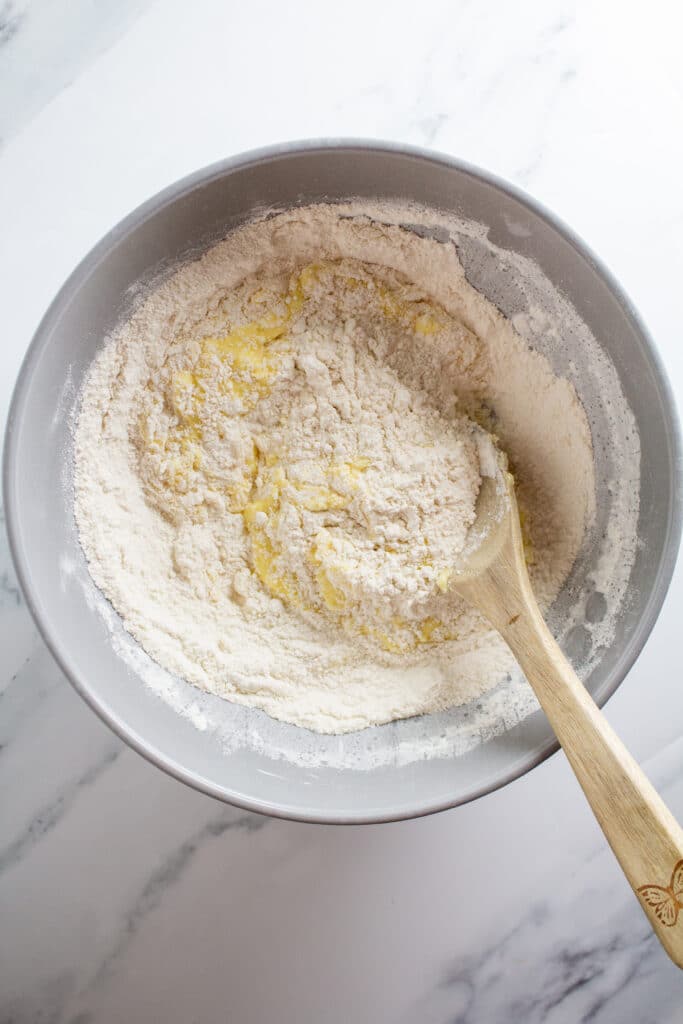 A bowl of wet and dry ingredients mixed halfway