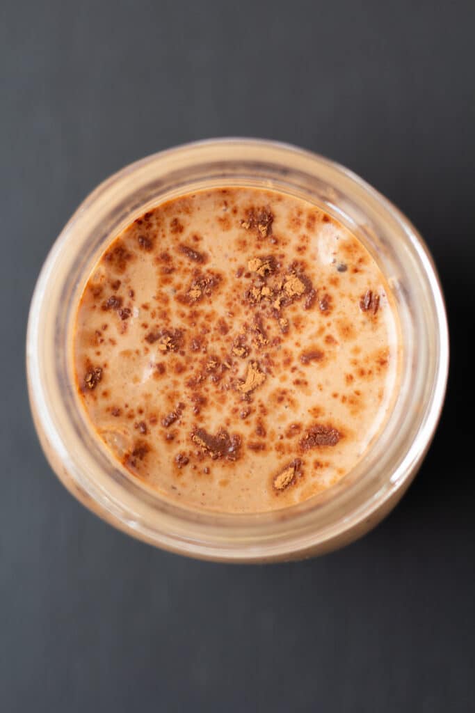 overhead view of a chocolate smoothie with cocoa powder on top