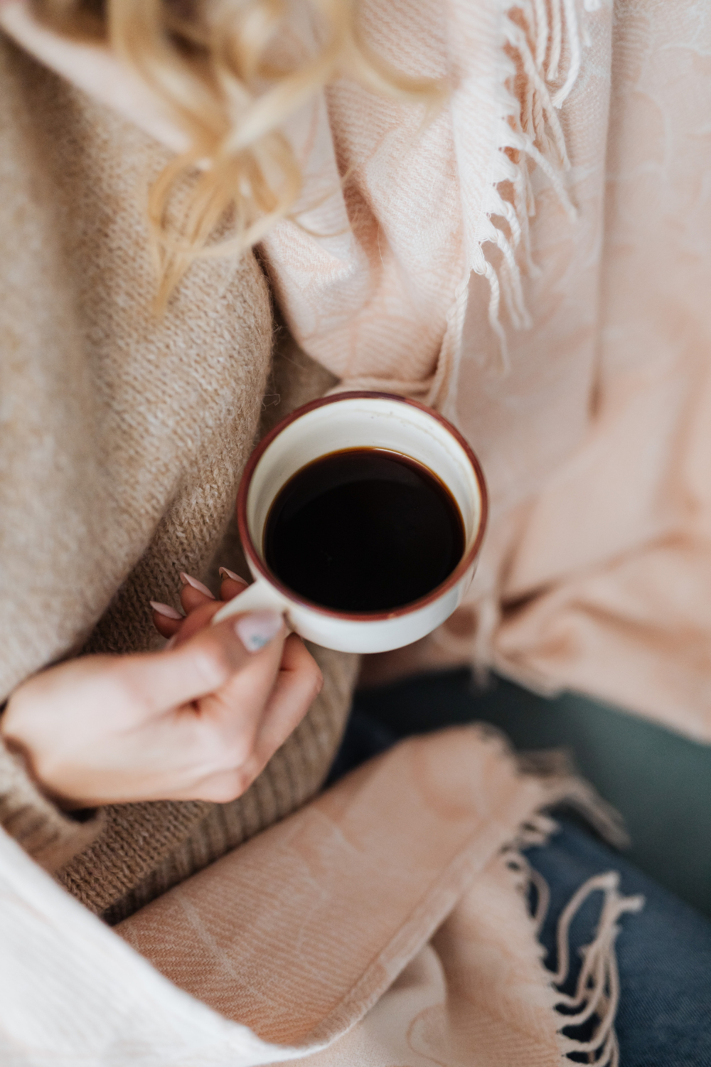 A woman holding a cup of coffee