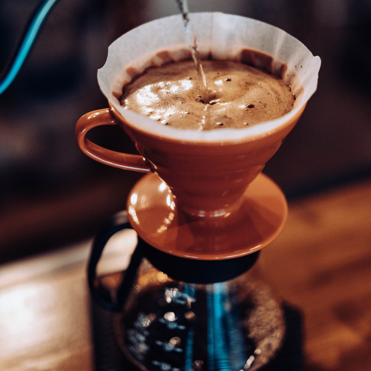 pour-over coffee filtering into a pot