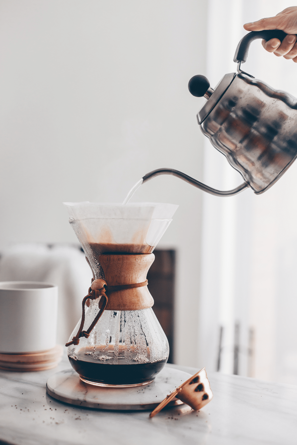 Pouring coffee into a fancy coffee pot