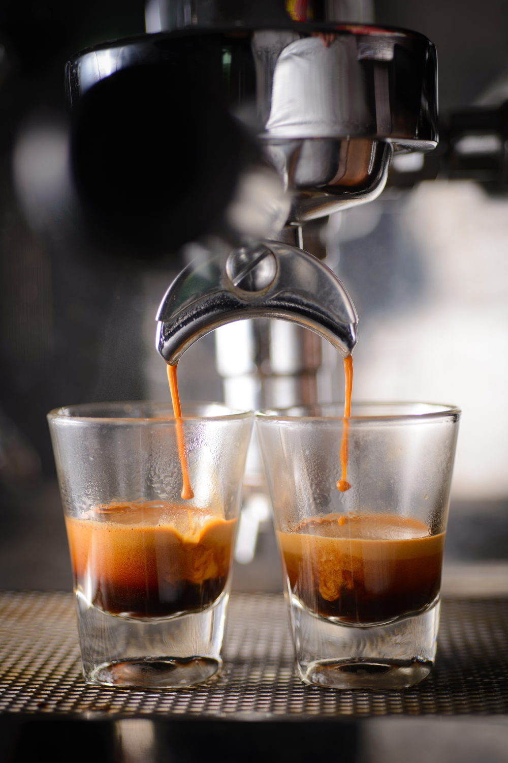 espresso pouring into two small glass cups