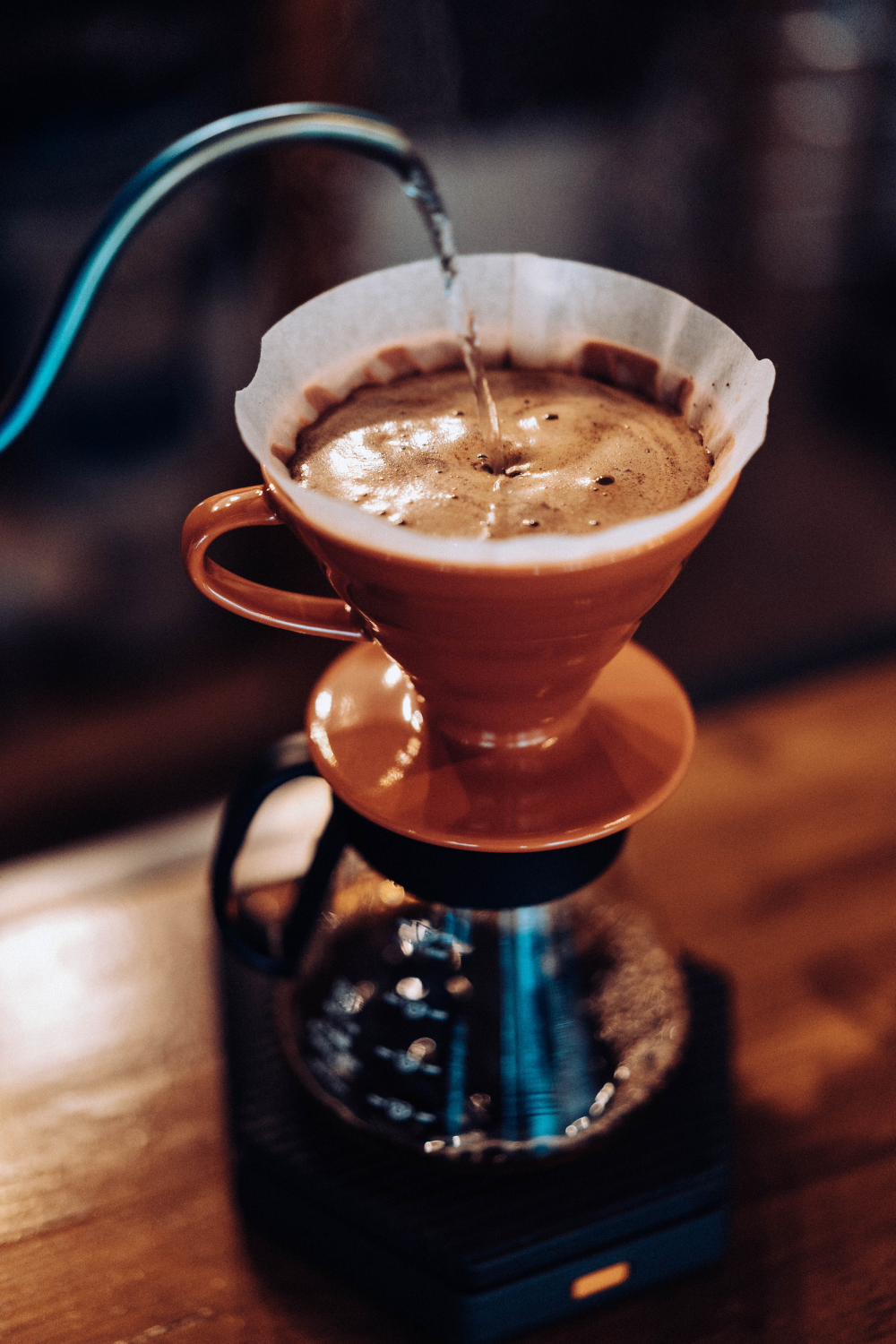 pour-over coffee filtering into a pot 