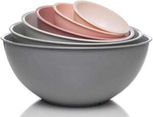 A set of plastic mixing bowls ranging in colors from gray to pink