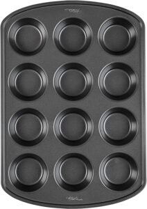 A dark gray muffin pan 