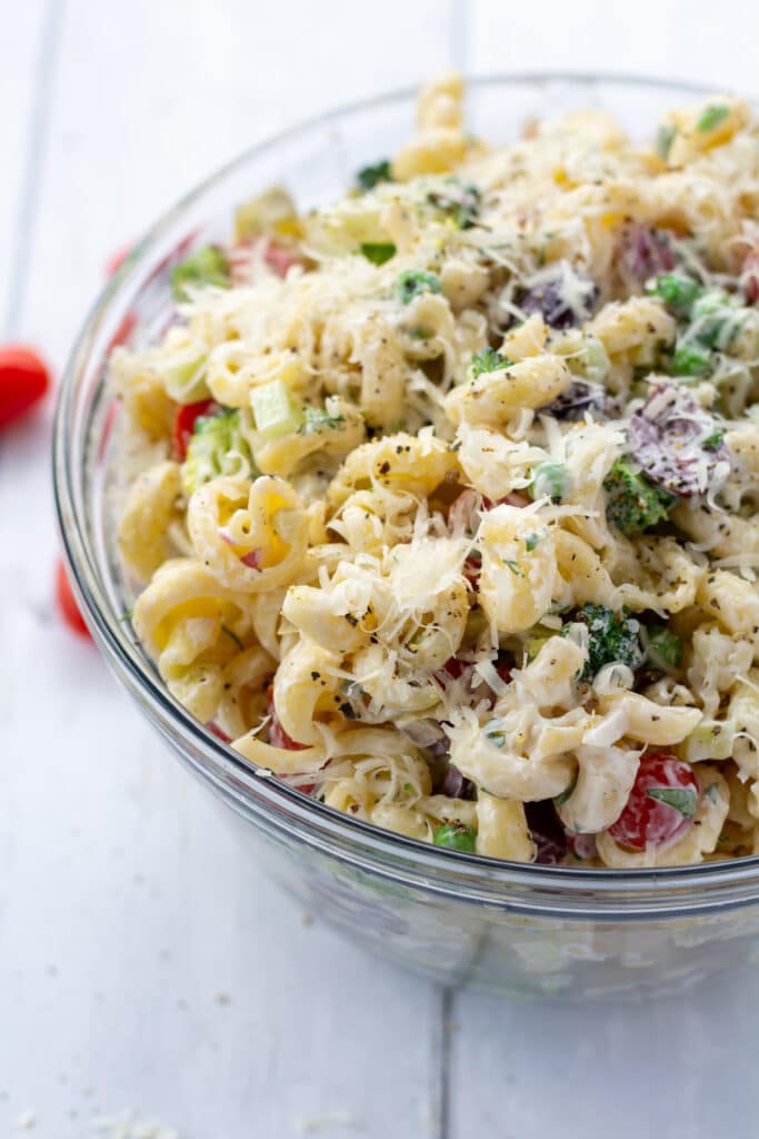 side view of healthy creamy bow tie pasta salad in a bowl